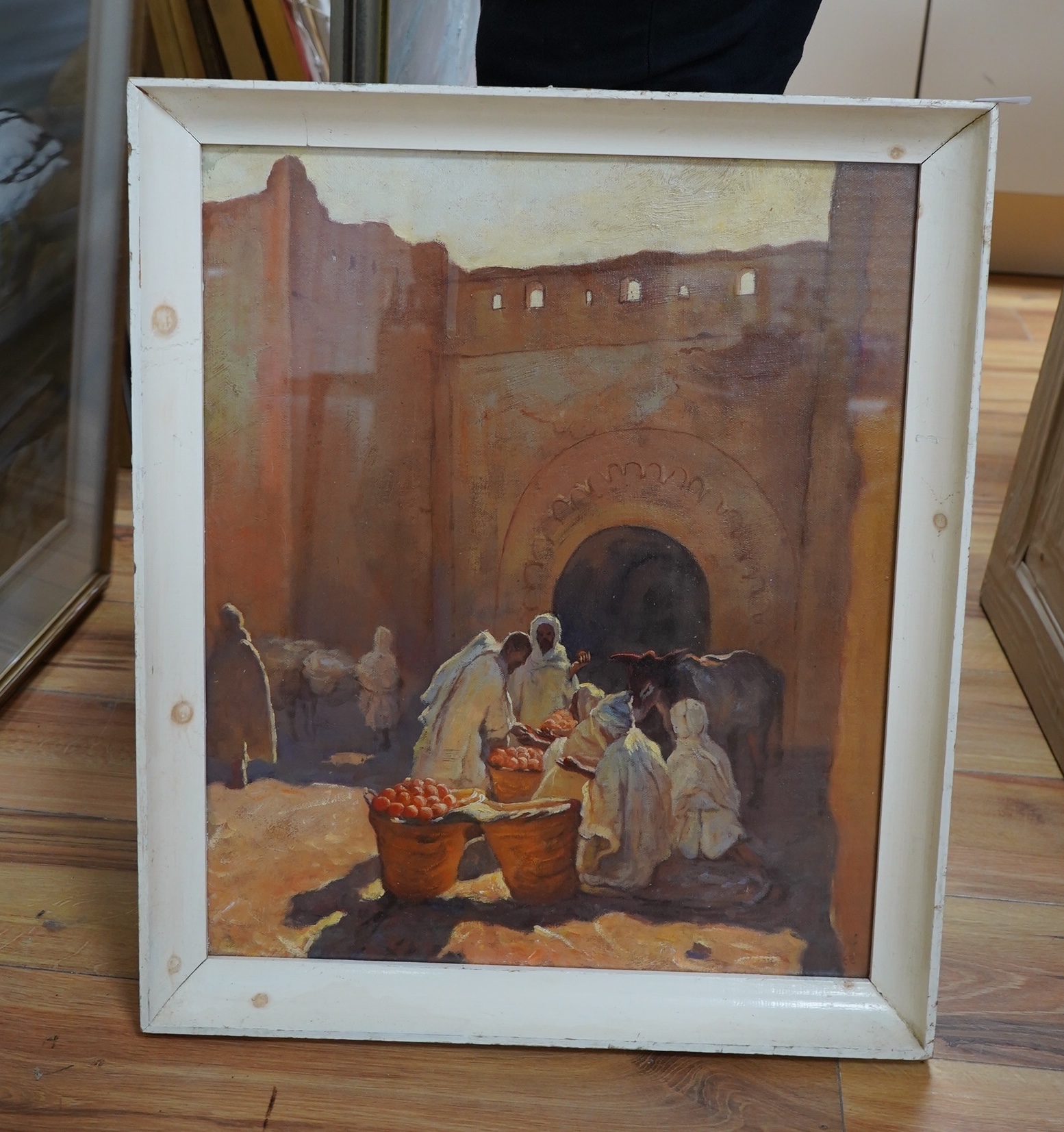 A decorative Orientalist style oil on board, Figures and donkey before an archway, 49 x 40cm. Condition - good